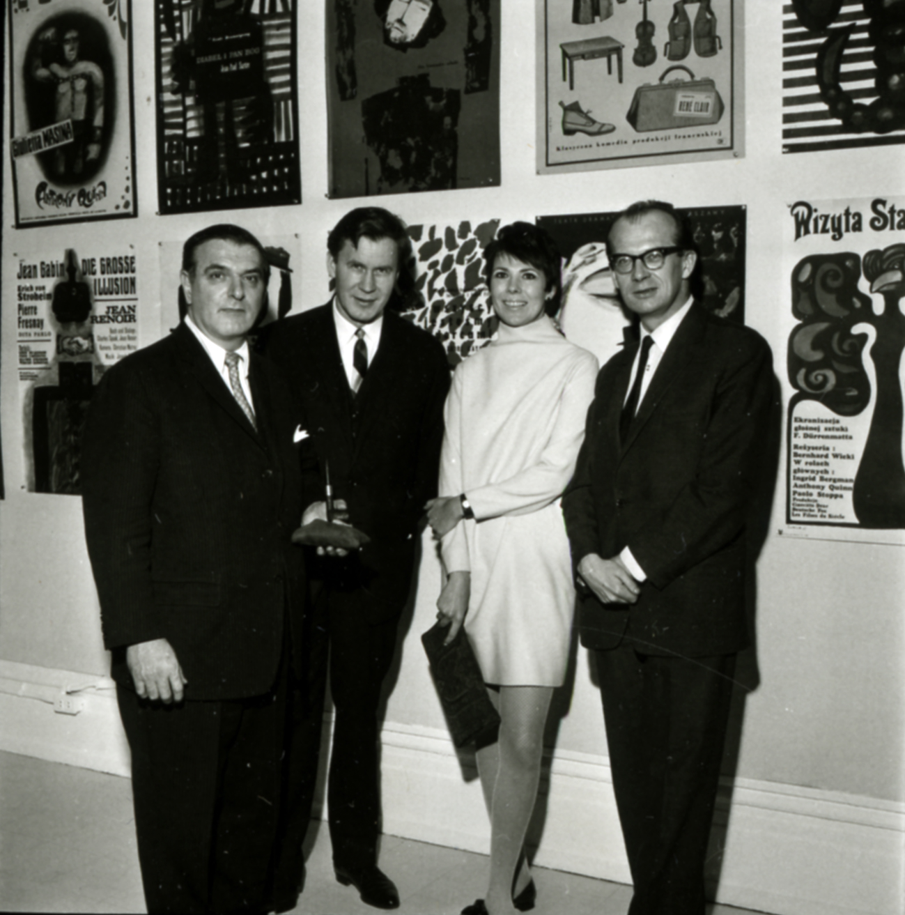 three men and woman at a gallery opening